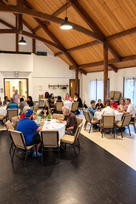 Community Hall Gathering Under Wooden Beams