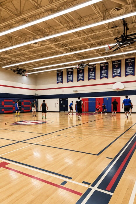Championship Banners Over A Busy Gym Court
