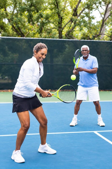 Joyful Tennis Rally On A Sunlit Court