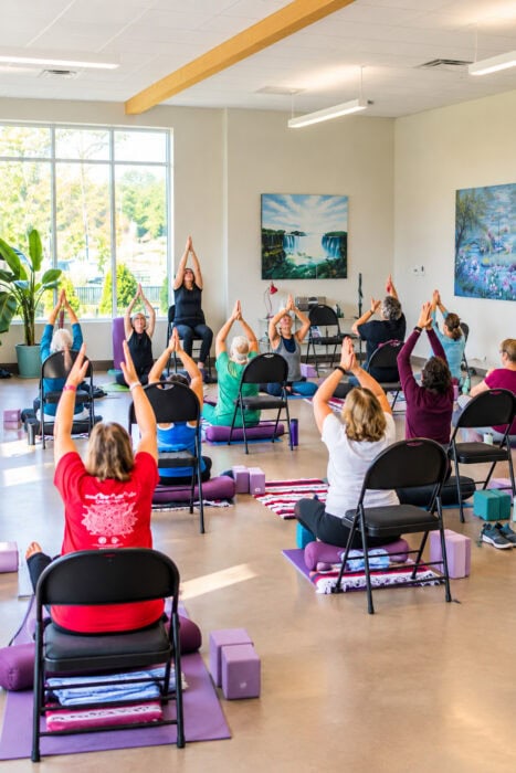 Seated Yoga Class In Sunlit Studio