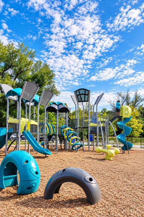 Vibrant Teal And Lime Playground Under Blue Skies